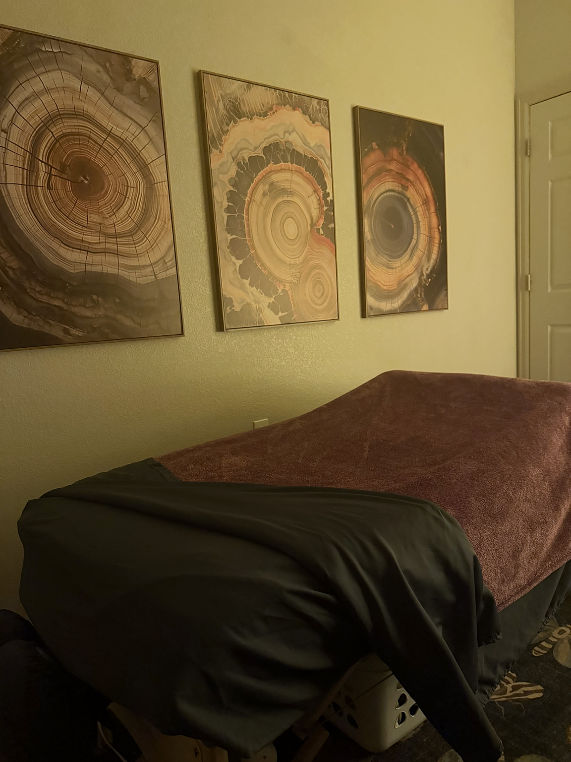 Rachel’s prepared massage table with wall art and patterned rug