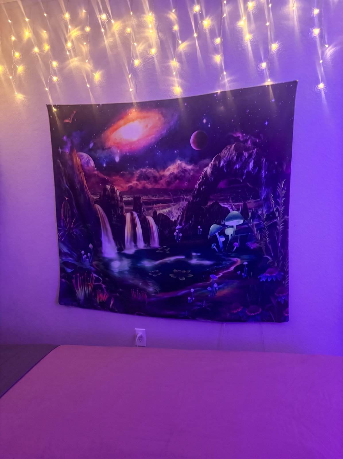 Landon's treatment room with a galaxy waterfall tapestry glowing under warm string lights