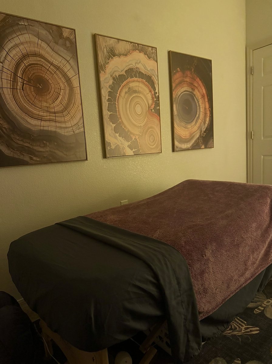 Rachel’s prepared massage table with wall art and patterned rug