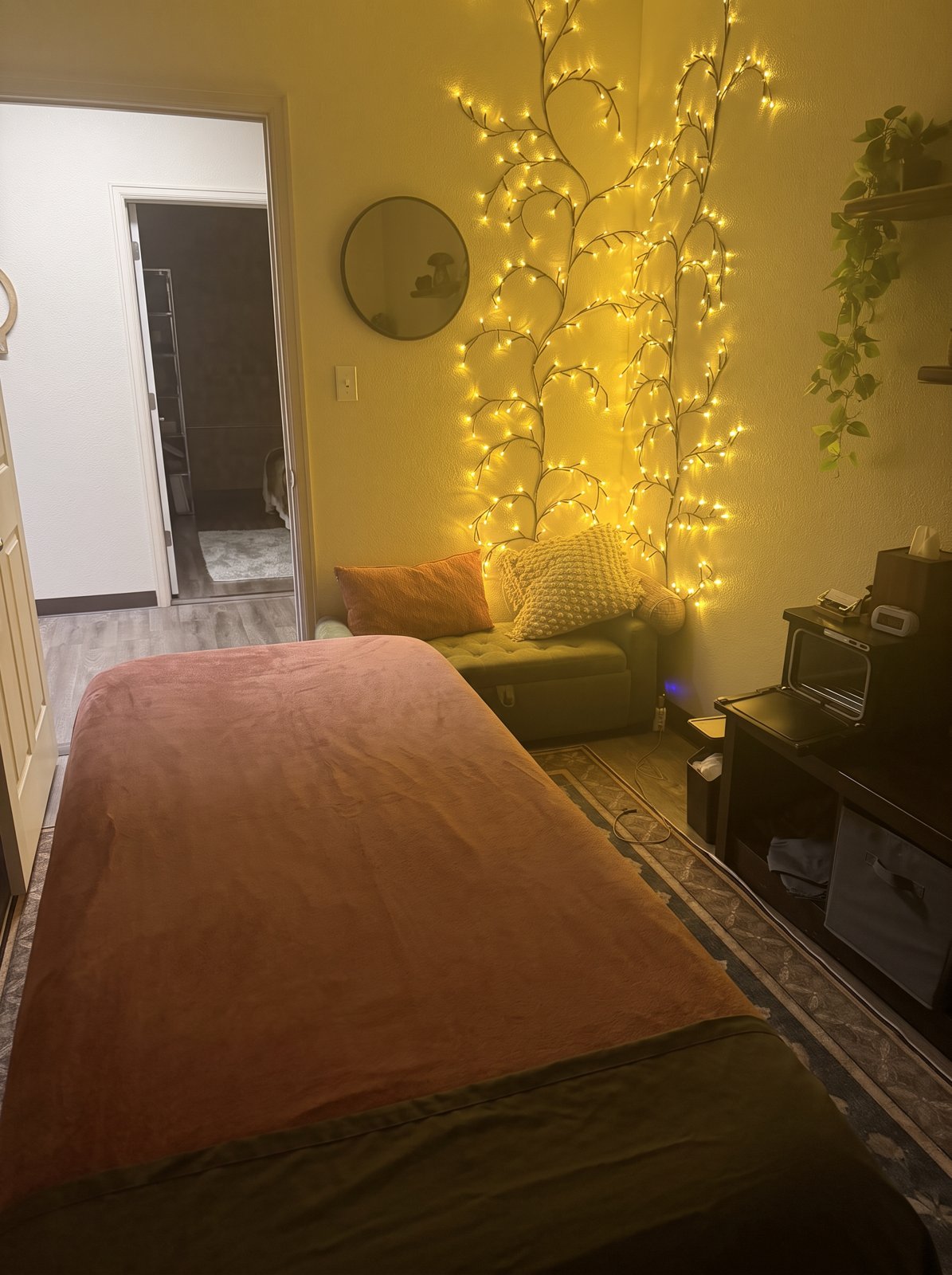 Rachel’s treatment room with warm string lights, a green chair, and its original open doorway